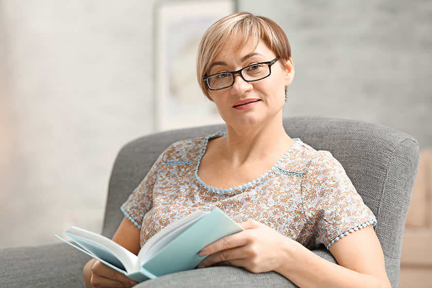 Woman wearing glasses while reading Woman wearing glasses while reading