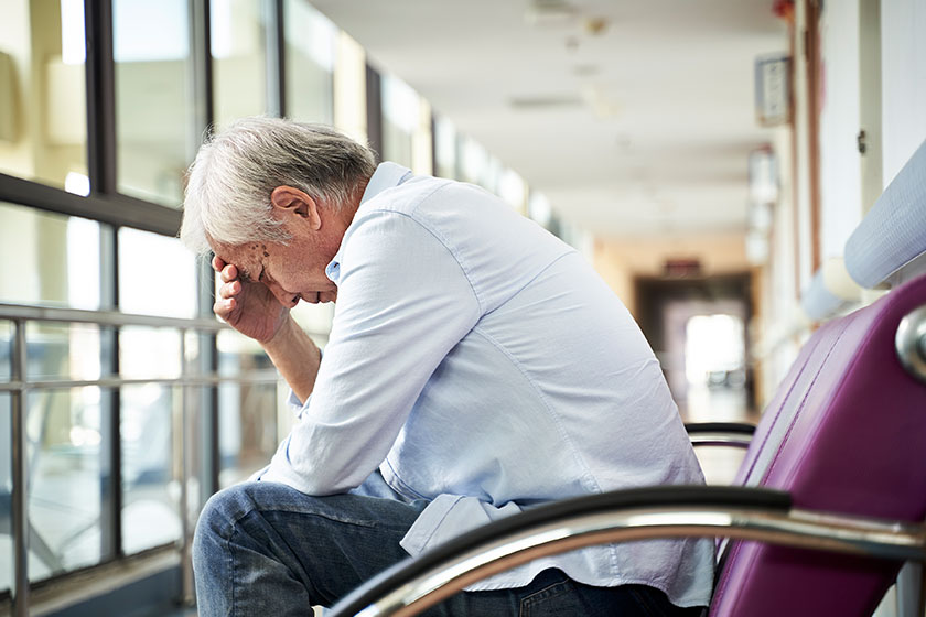 Asian old man sitting in hospital hallway Asian old man sitting in hospital hallway