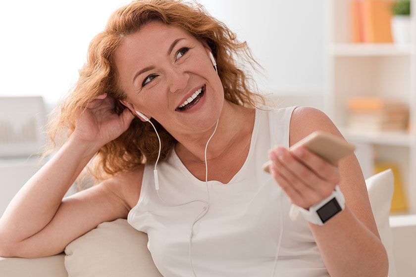 Cheerful woman listening to music
