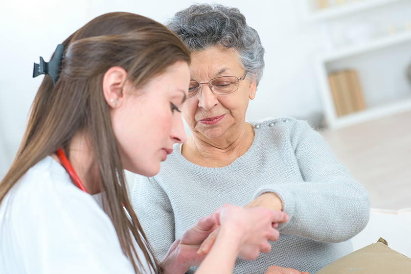 Female doctor with older patient Female doctor with older patient