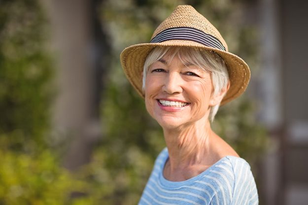 Happy senior woman in straw hat Happy senior woman in straw hat