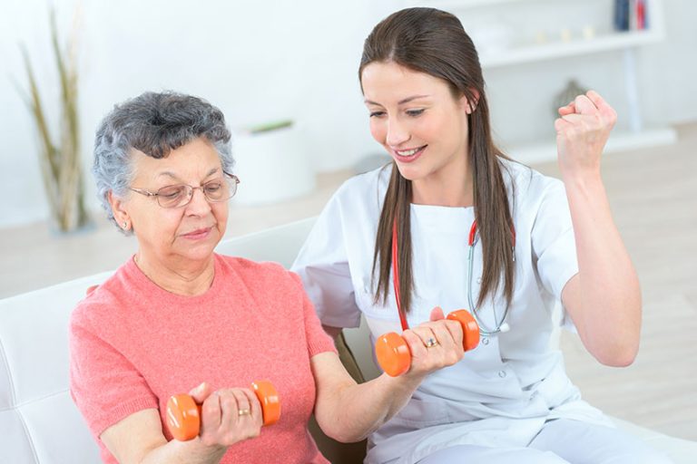 Helping senior woman work out