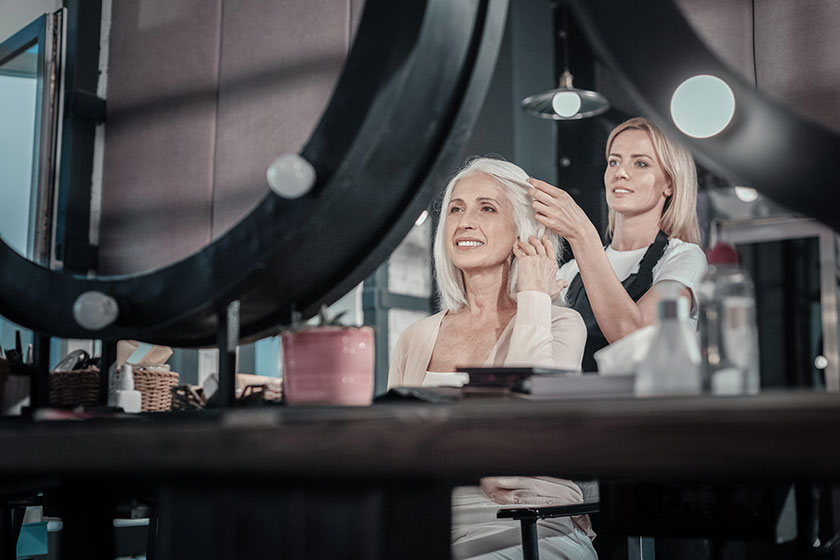 Joyful positive woman looking at her reflection