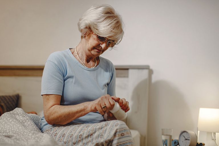 Mature woman taking a pill