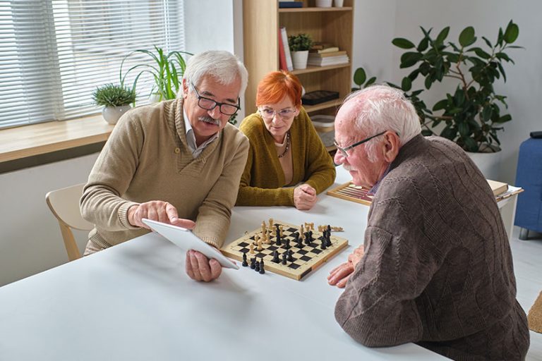 Senior people learning to play chess Senior people learning to play chess
