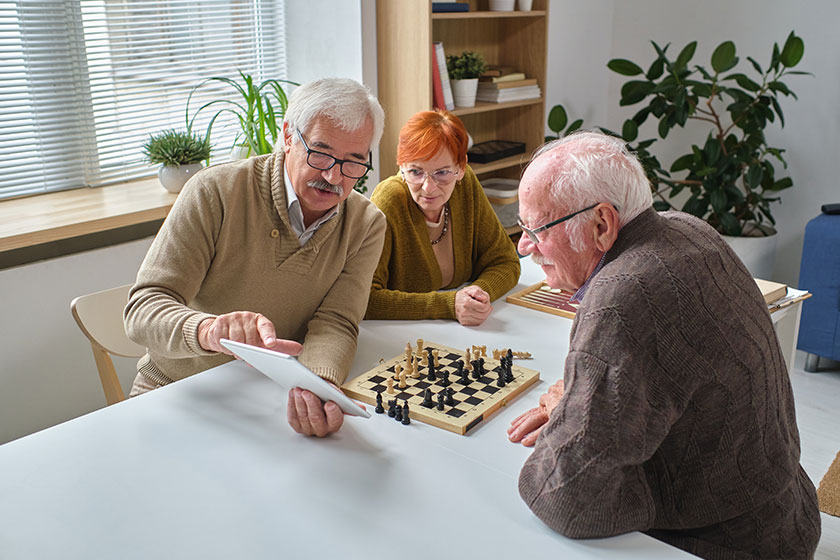 Senior people learning to play chess Senior people learning to play chess