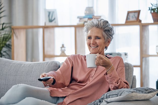 Senior woman, sofa and coffee to relax
