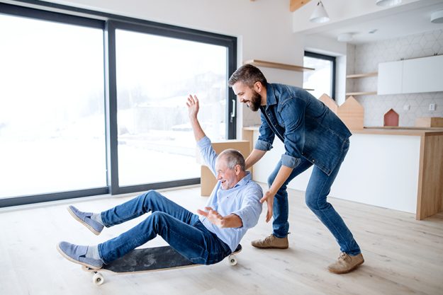Two men having fun when furnishing new house