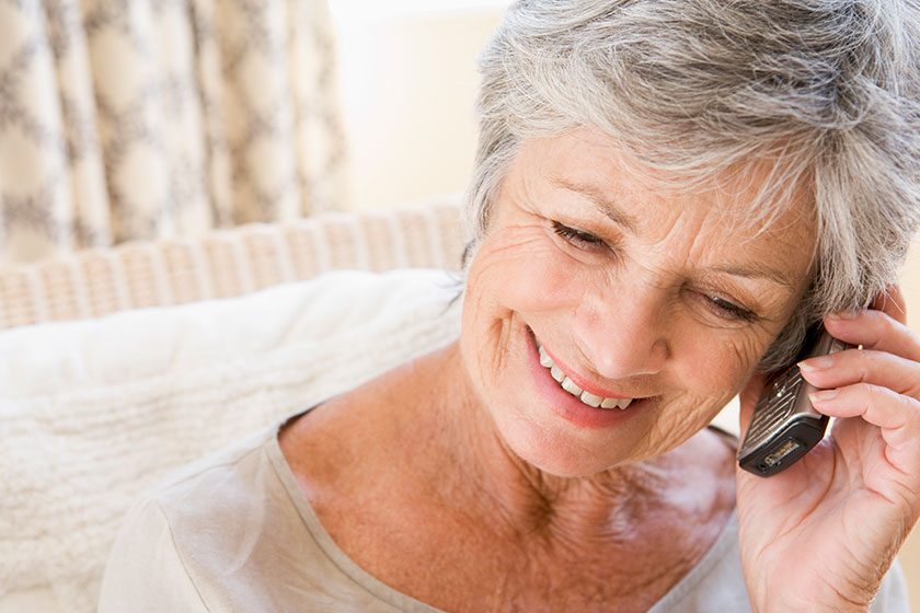 Woman indoors using cellular phone