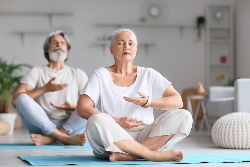 Mature couple practicing yoga at home a-guide-to-breathing-meditation-in-assisted-living-homes-in-tampa-fl