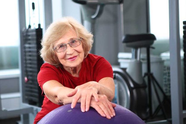 An elderly woman goes in for sports