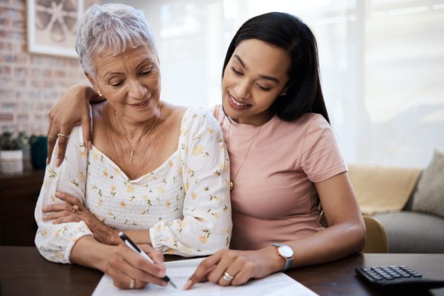 Giving mom the gift of a comfortable retirement. a young woman going over paperwork with her elderly mother at home. Giving mom the gift of a comfortable retirement. a young woman going over paperwork with her elderly mother at home.