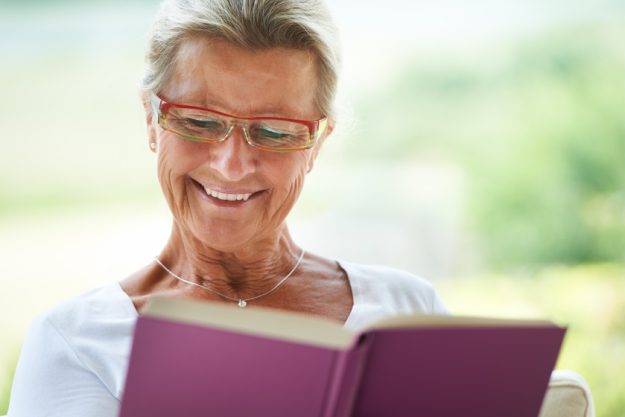 This is such a great story. A delighted woman reading an enjoyable book in her lounge. how-55-communities-in-florida-can-improve-your-intellectual-well-being
