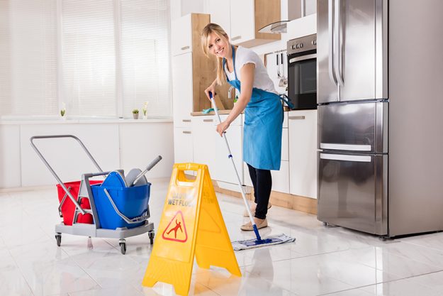 Woman Cleaning Kitchen Floor Woman Cleaning Kitchen Floor