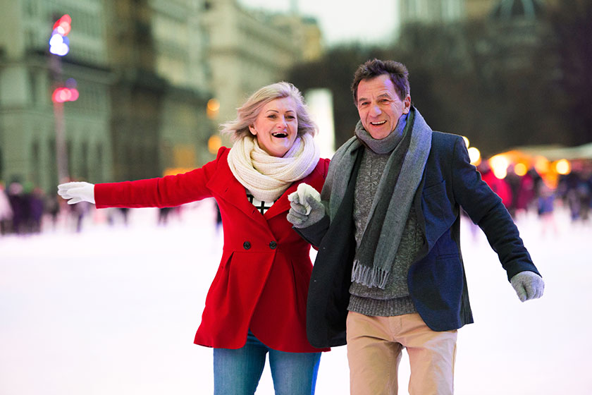 Beautiful senior couple ice skating