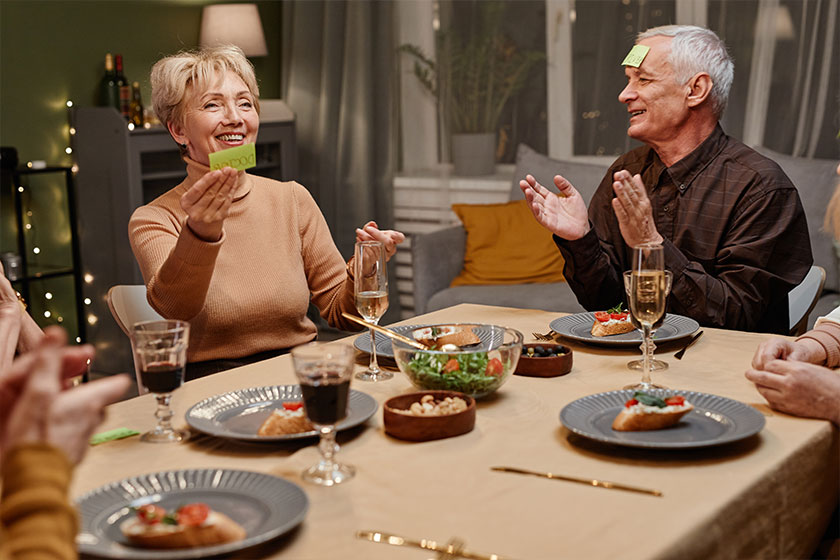 Cheerful aged people playing guessing game