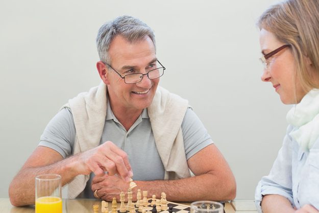Couple playing chess at home