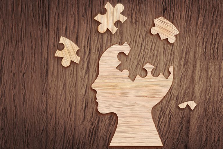 Human head silhouette with a jigsaw piece cut out Human head silhouette with a jigsaw piece cut out