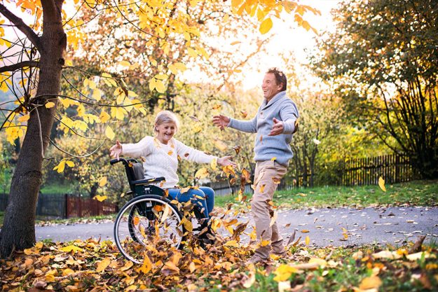 Senior couple in wheelchair in autumn nature. Senior couple in wheelchair in autumn nature.