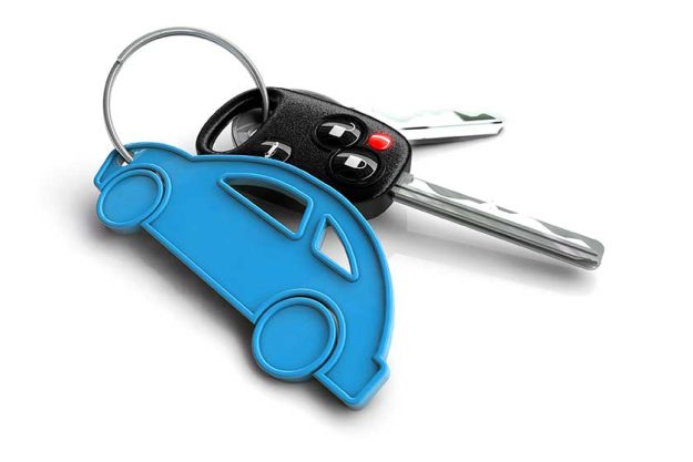 Car keys with pink passenger vehicle icon as keyring