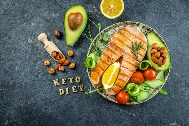 Dish grilled salmon steak avocado fresh vegetable salad keto diet Dish grilled salmon steak avocado fresh vegetable salad keto diet