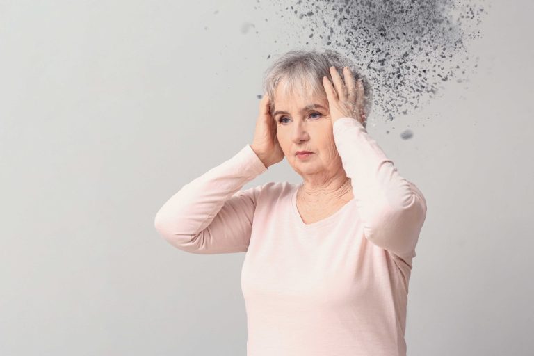 Elderly woman suffering from headache on grey background Elderly woman suffering from headache on grey background