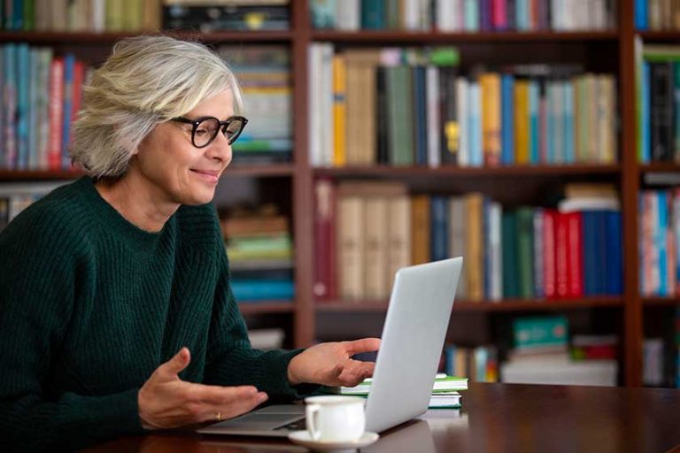 A elderly woman use the laptop for Internet conversation. The modern lifestyle of seniors A elderly woman use the laptop for Internet conversation. The modern lifestyle of seniors