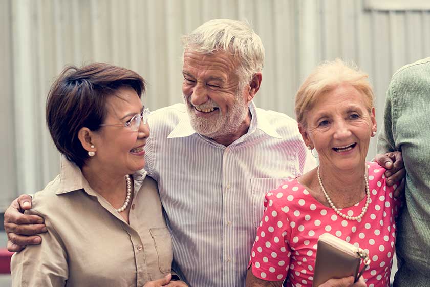 Stylish senior people in front of gray wall Stylish senior people in front of gray wall