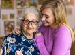 Young woman spending time with her elderly grandmother at home