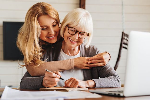 Adult daughter helping senior woman Adult daughter helping senior woman
