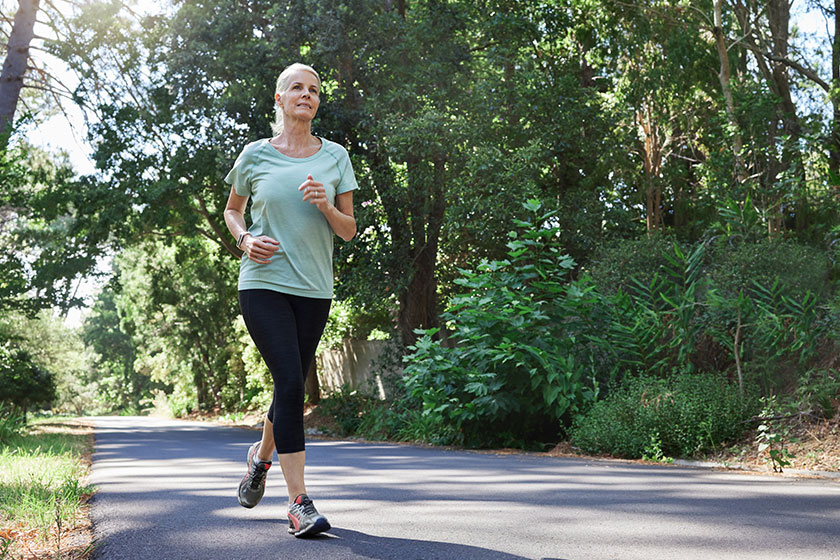 low angle shot mature woman running outdoors