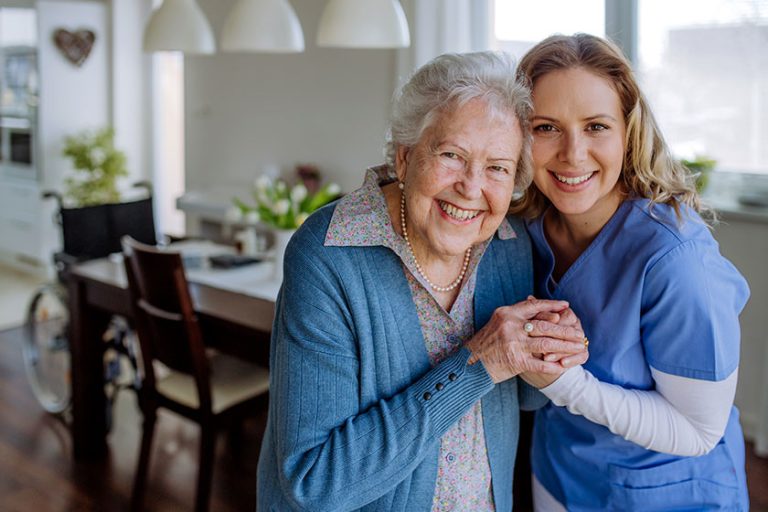 nurse hugging her senior woman client