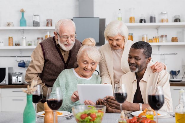 Senior multicultural people looking at digital tablet