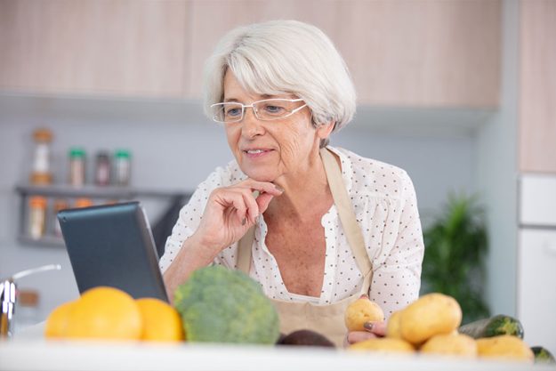 Woman watching online culinary class Woman watching online culinary class