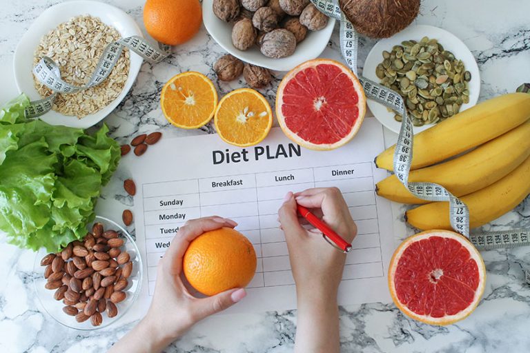 Young woman writing a diet plan Young woman writing a diet plan