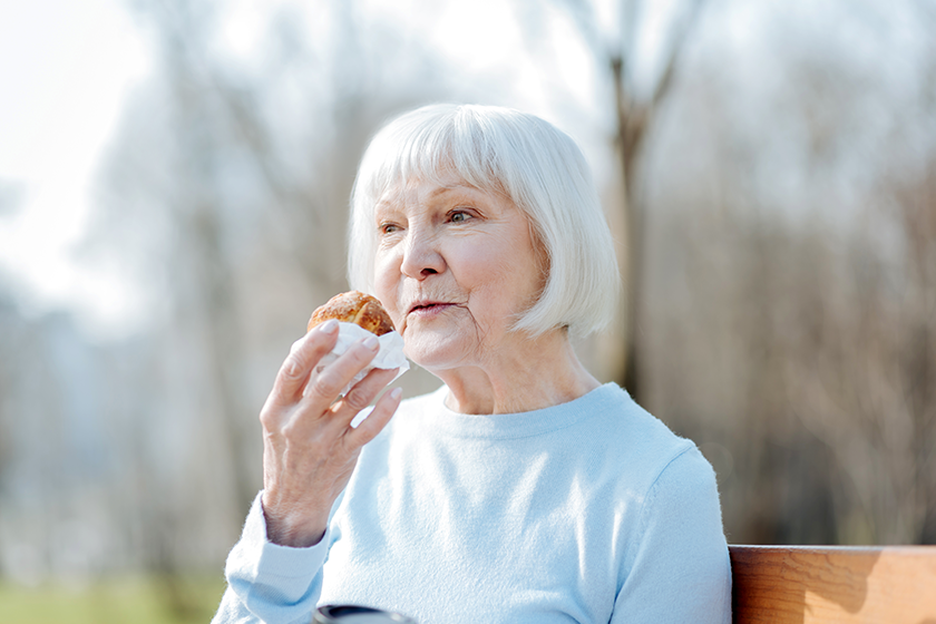 Delighted woman enjoying her cookie