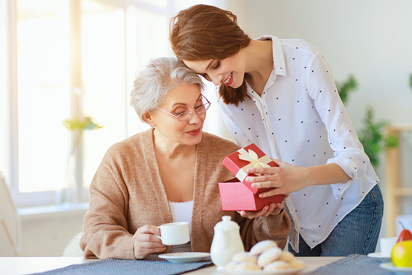 Happy mother's day! adult daughter gives gift and congratulates