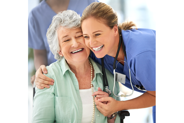 An attractive female nurse and her senior patient in the hospital An attractive female nurse and her senior patient in the hospital