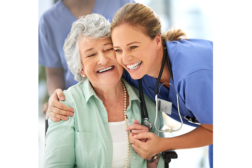 An attractive female nurse and her senior patient in the hospital An attractive female nurse and her senior patient in the hospital
