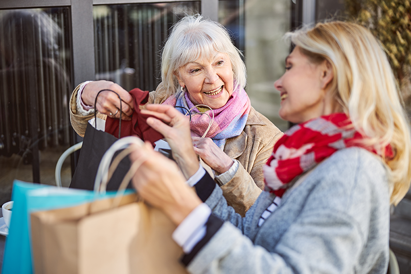 Laughing cheerful women talking together in the open air cafe Laughing cheerful women talking together in the open air cafe