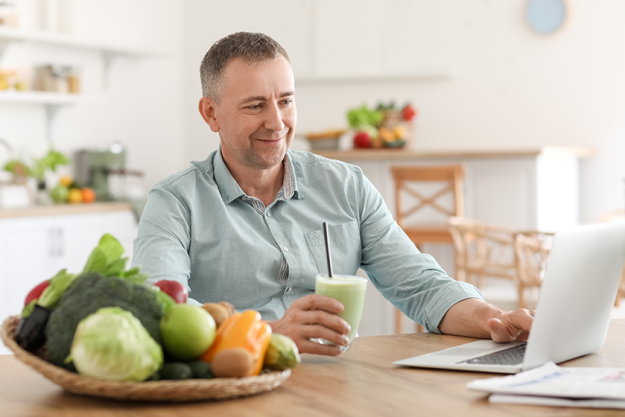 Mature man with glass of fresh vegetable Mature man with glass of fresh vegetable