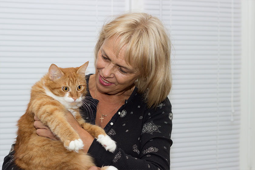 An elderly woman and a cat