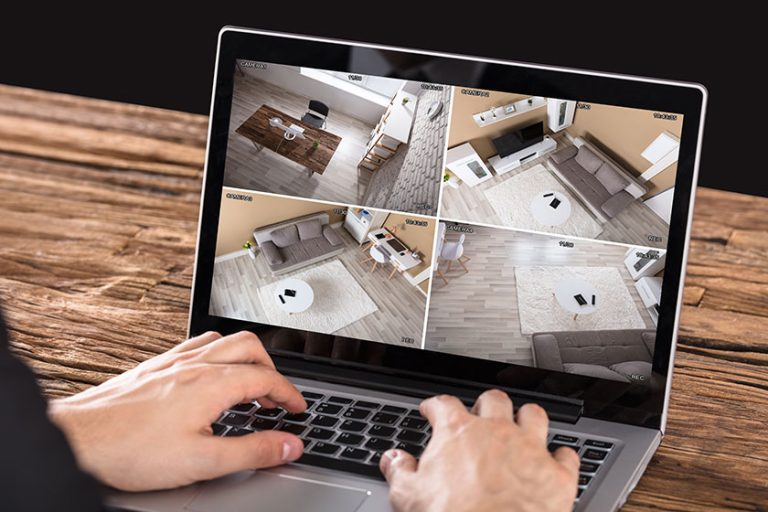 businessperson looking at security camera on laptop