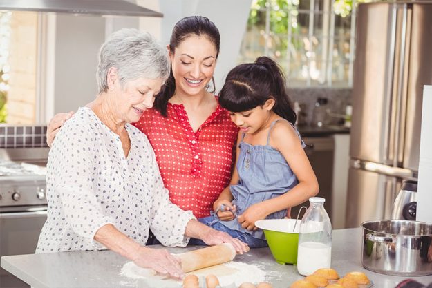Grandmother with family making bread