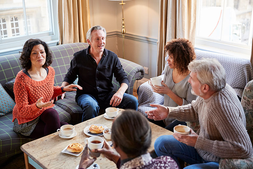Group middle aged friends meeting table coffee shop Group middle aged friends meeting table coffee shop