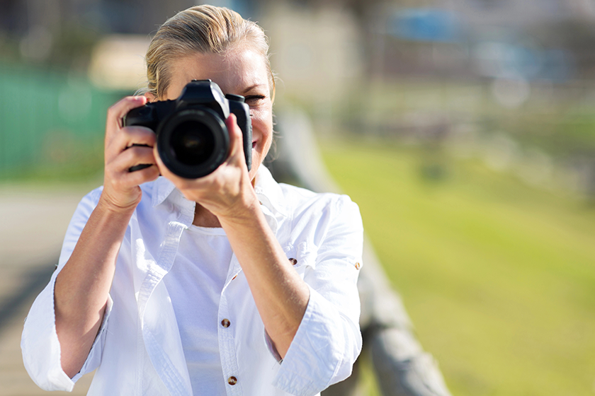 Mature female photographer taking photos