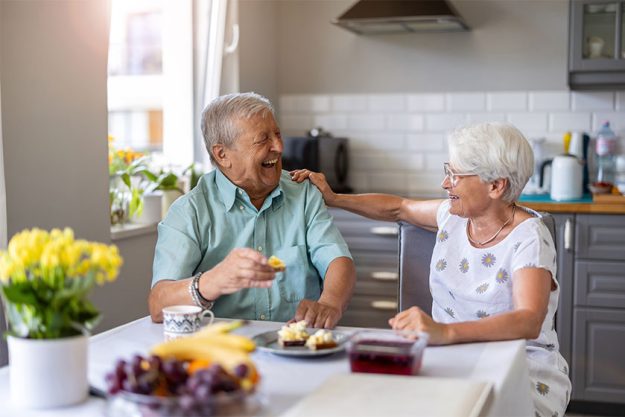 Senior couple having breakfast and talking
