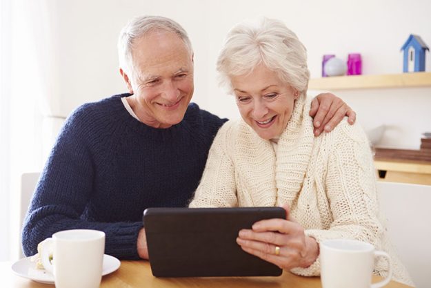 senior couple using digital tablet