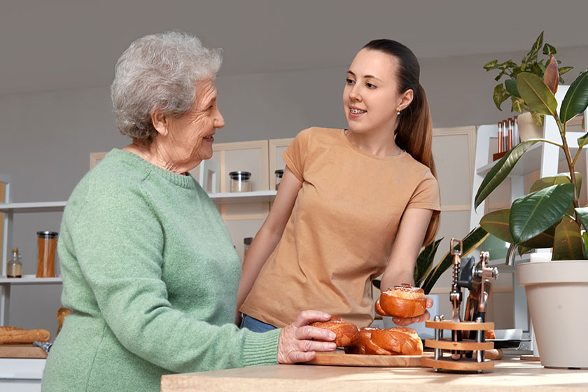 senior woman her granddaughter tasty buns kitchen senior woman her granddaughter tasty buns kitchen