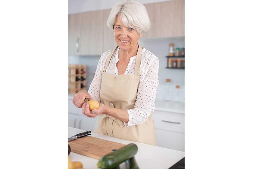 attractive mature woman peeling potatoes kitchen attractive mature woman peeling potatoes kitchen